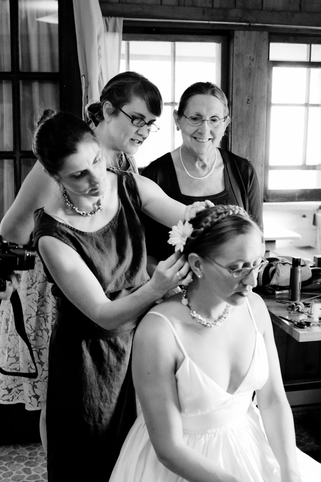 Bridesmaids helping a bride with her beautiful wedding dress