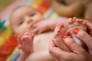 closeup of baby's feet in mothers hands